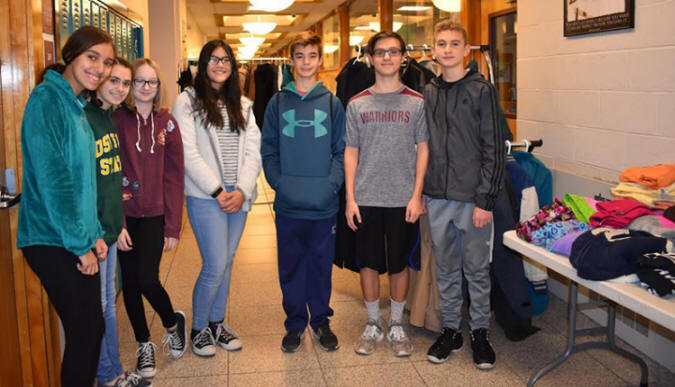 students at the Middle and High School Friends of Rachel Club Coat Giveaway pose for a picture