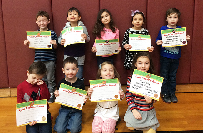 Kindergartners pose with their Character Education Leader Awards