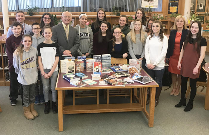 Rep. Paul Tonko poses for a picture with Stillwater students and staff after donating books to the Middle/High School Library.