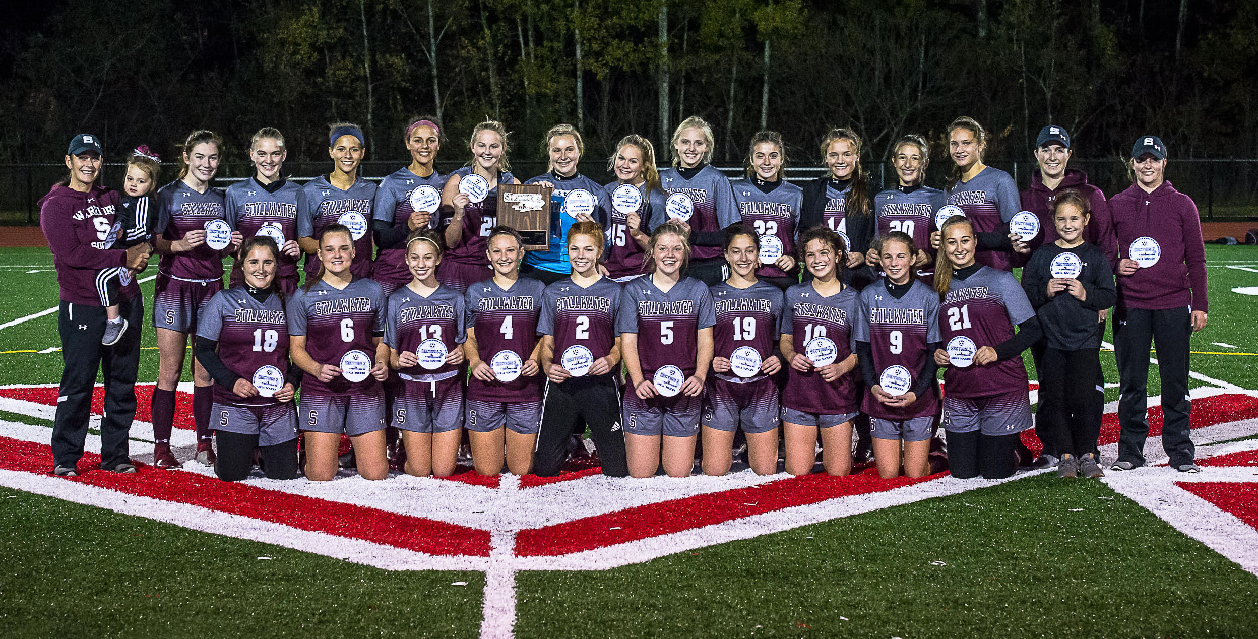 Athletes gathered on the field for a group photo