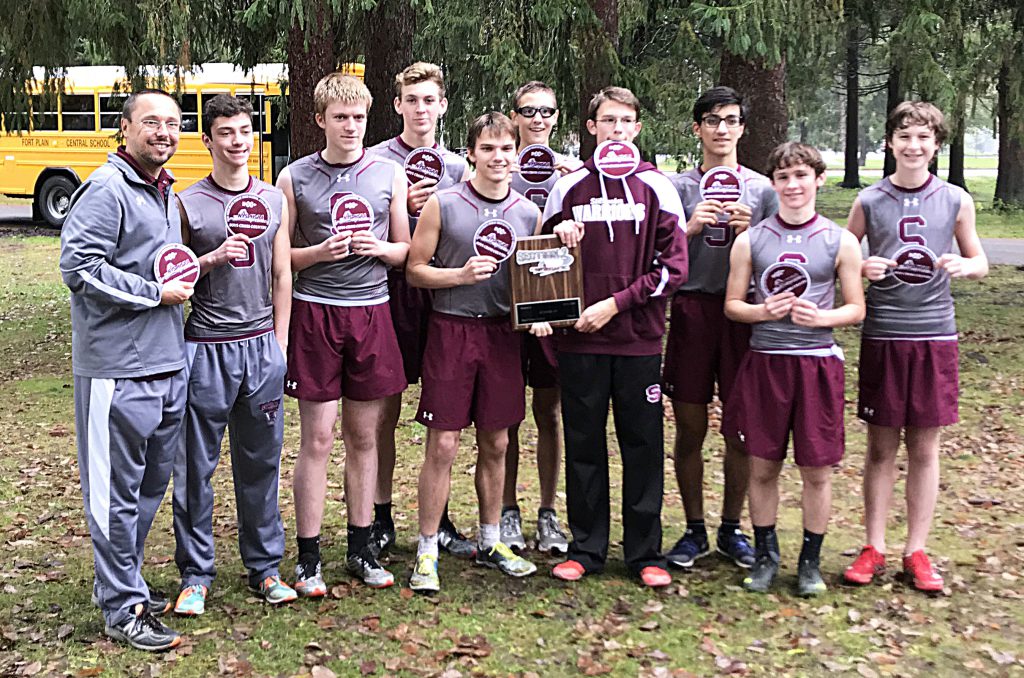 Boys cross country team poses for a picture with trophy