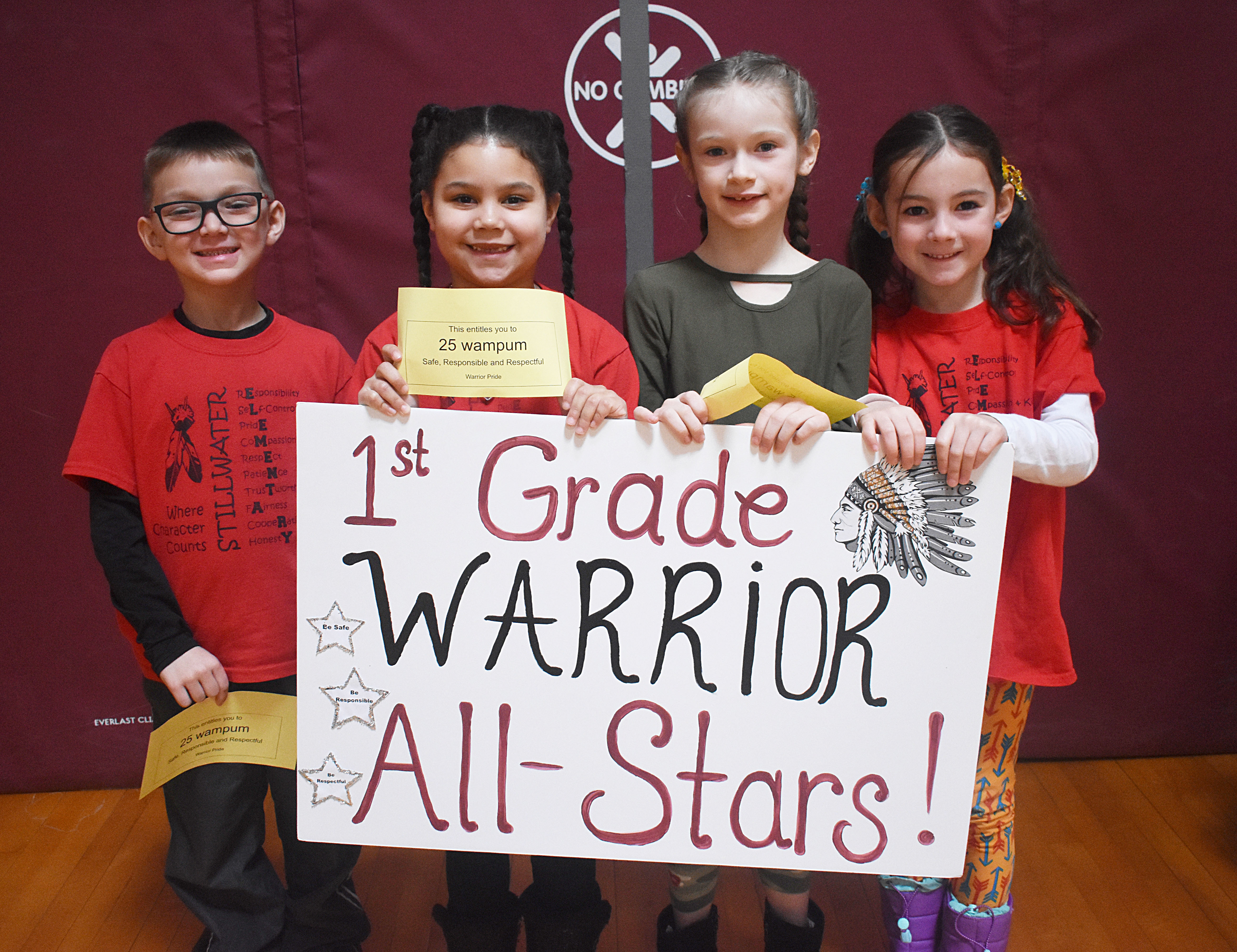 Students grouped together for a photo with their grade level sign