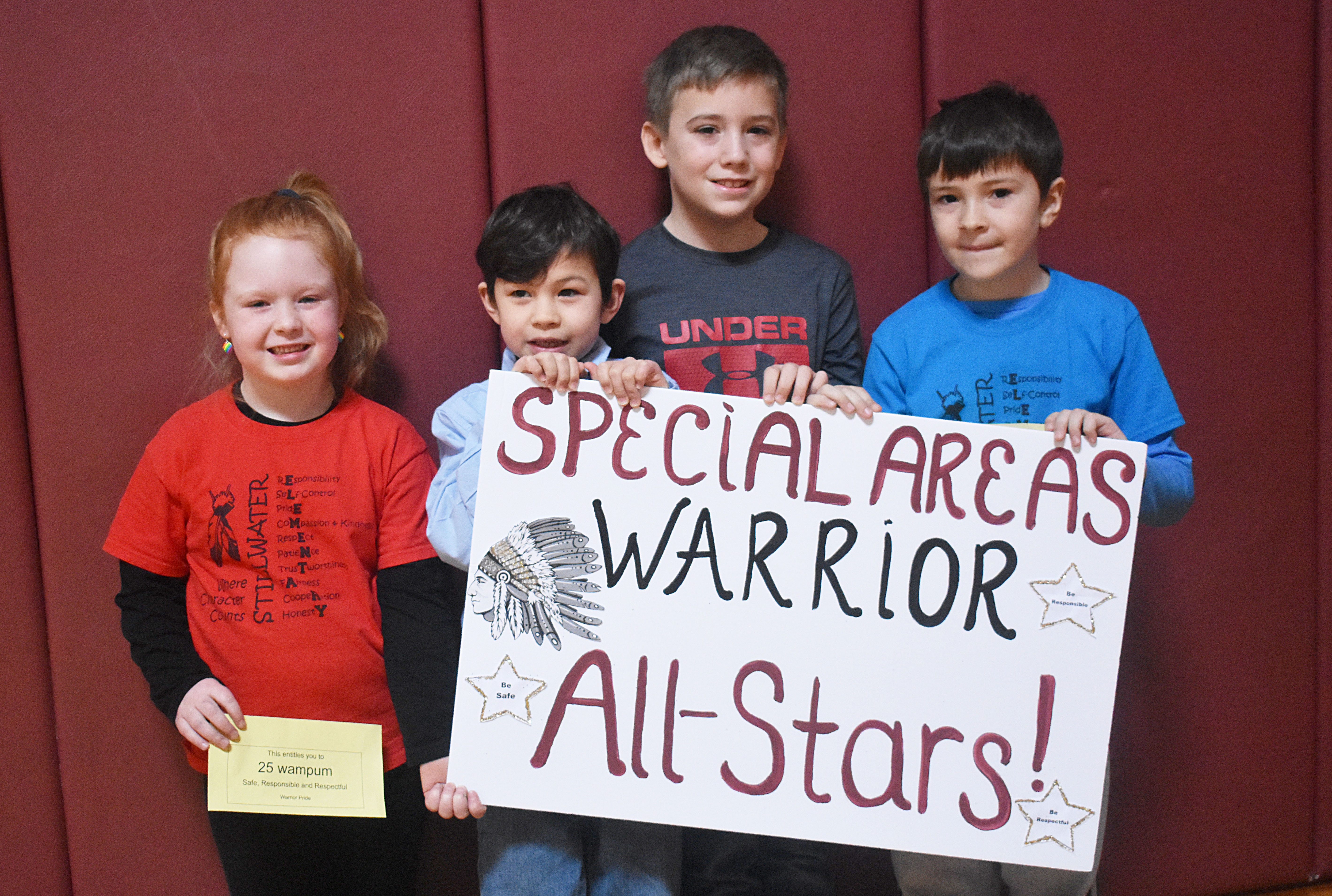 Students grouped together holding the specials sign