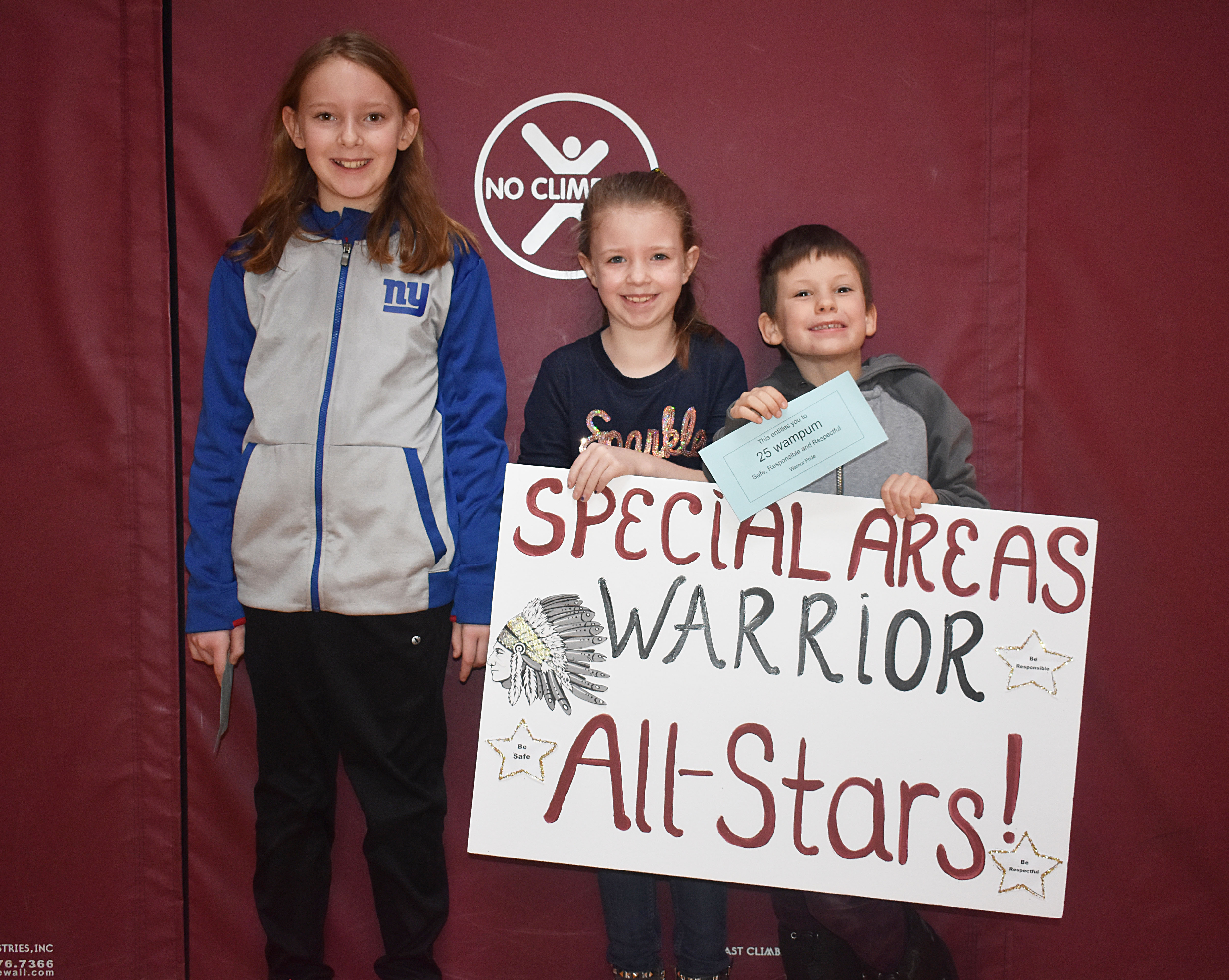 Three students standing with the specials sign