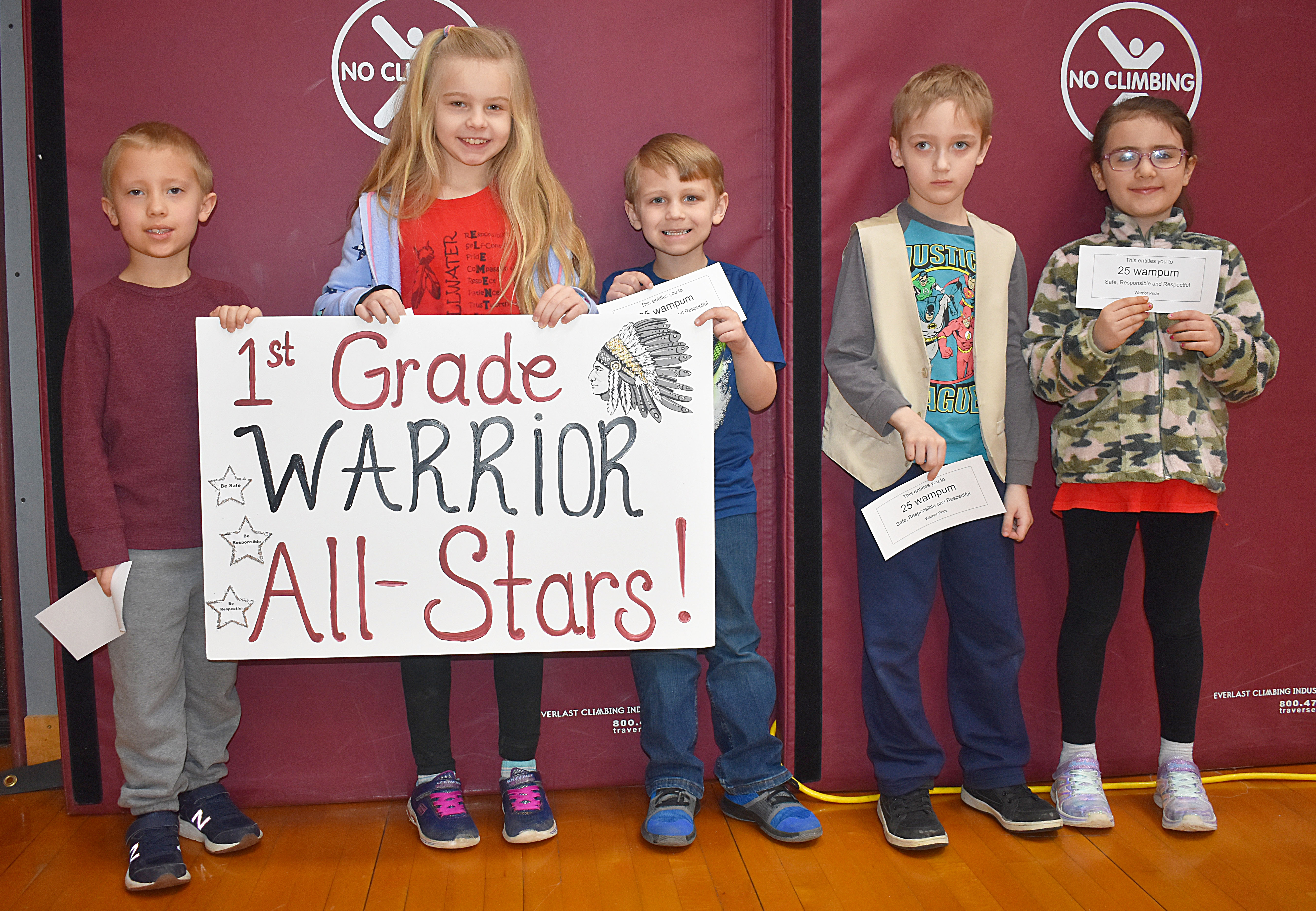 Group of students gathered with the first grade all stars sign