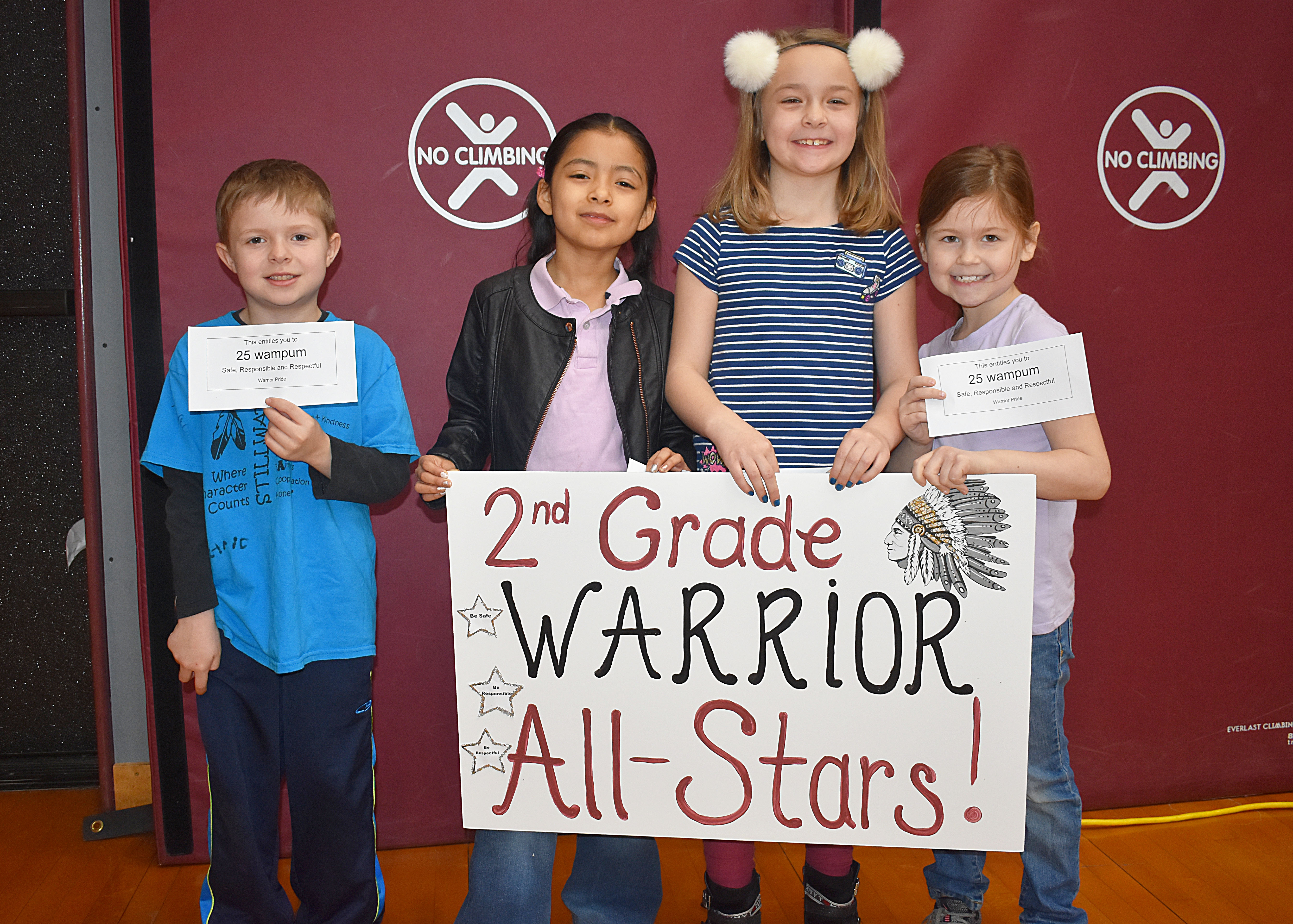 Group of second grade students gathered with second grade sign