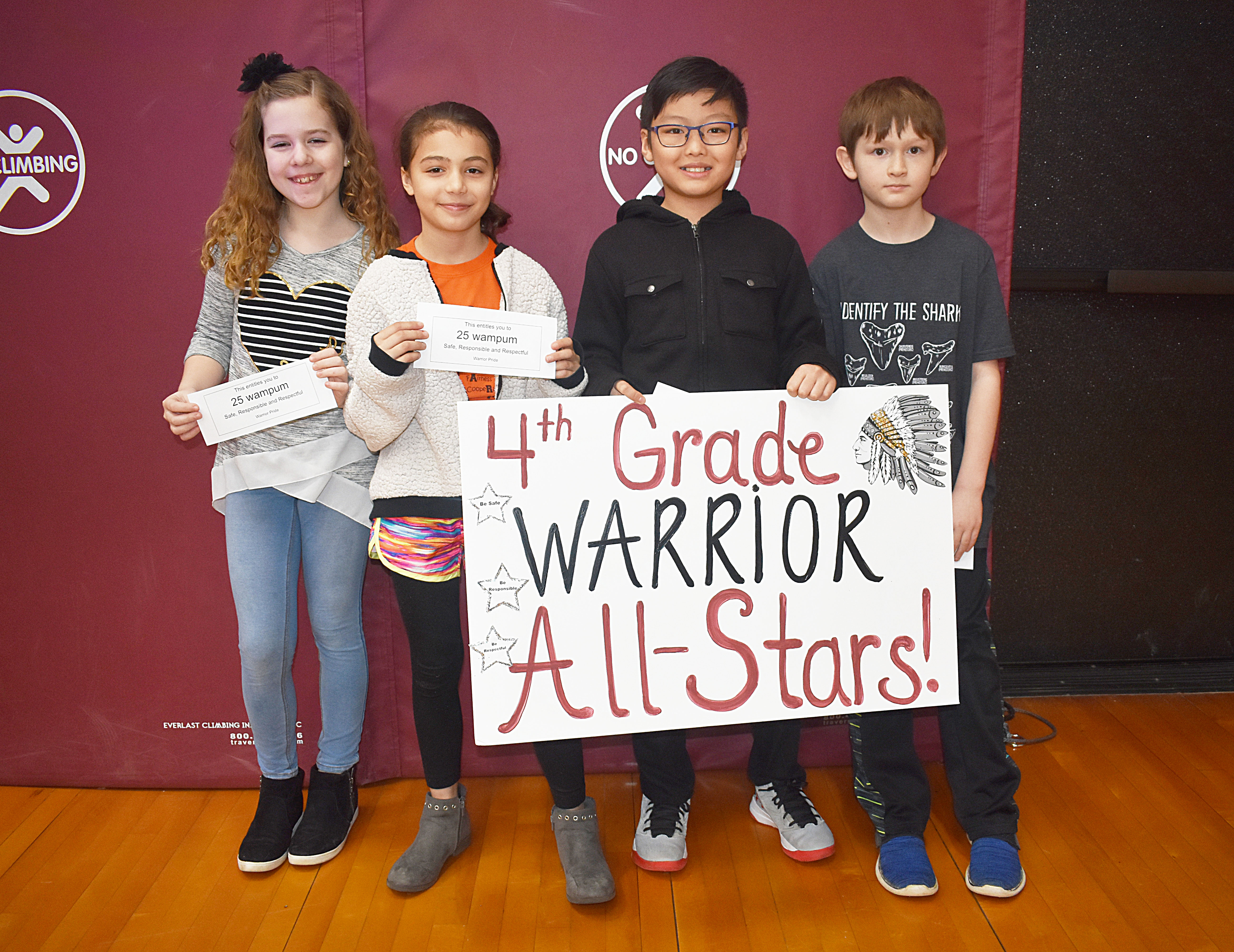 Group of fourth grade students gathered for a picture with the fourth grade all star sign