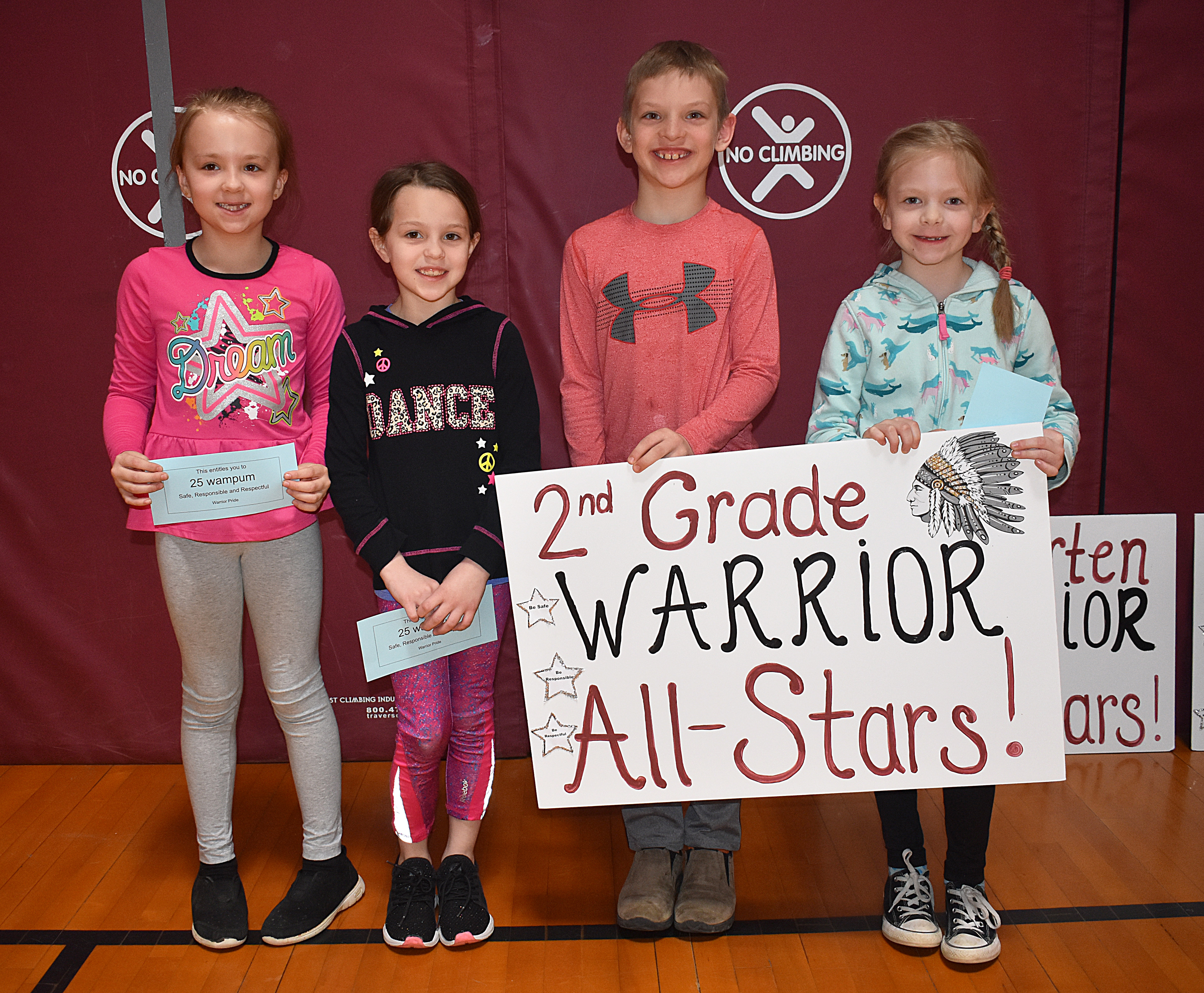 Kid standing together with second grade sign