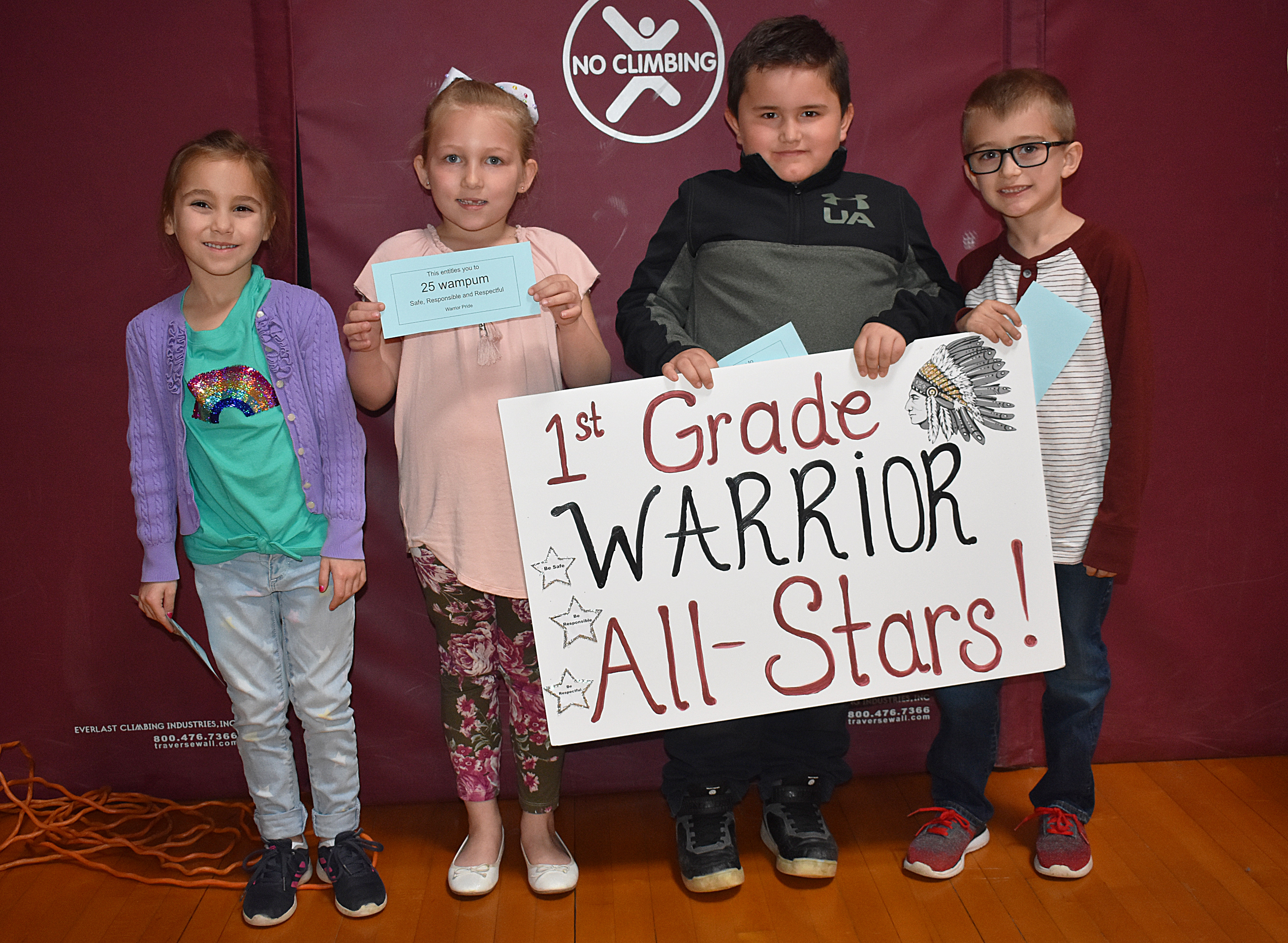 Kids standing together with first grade sign