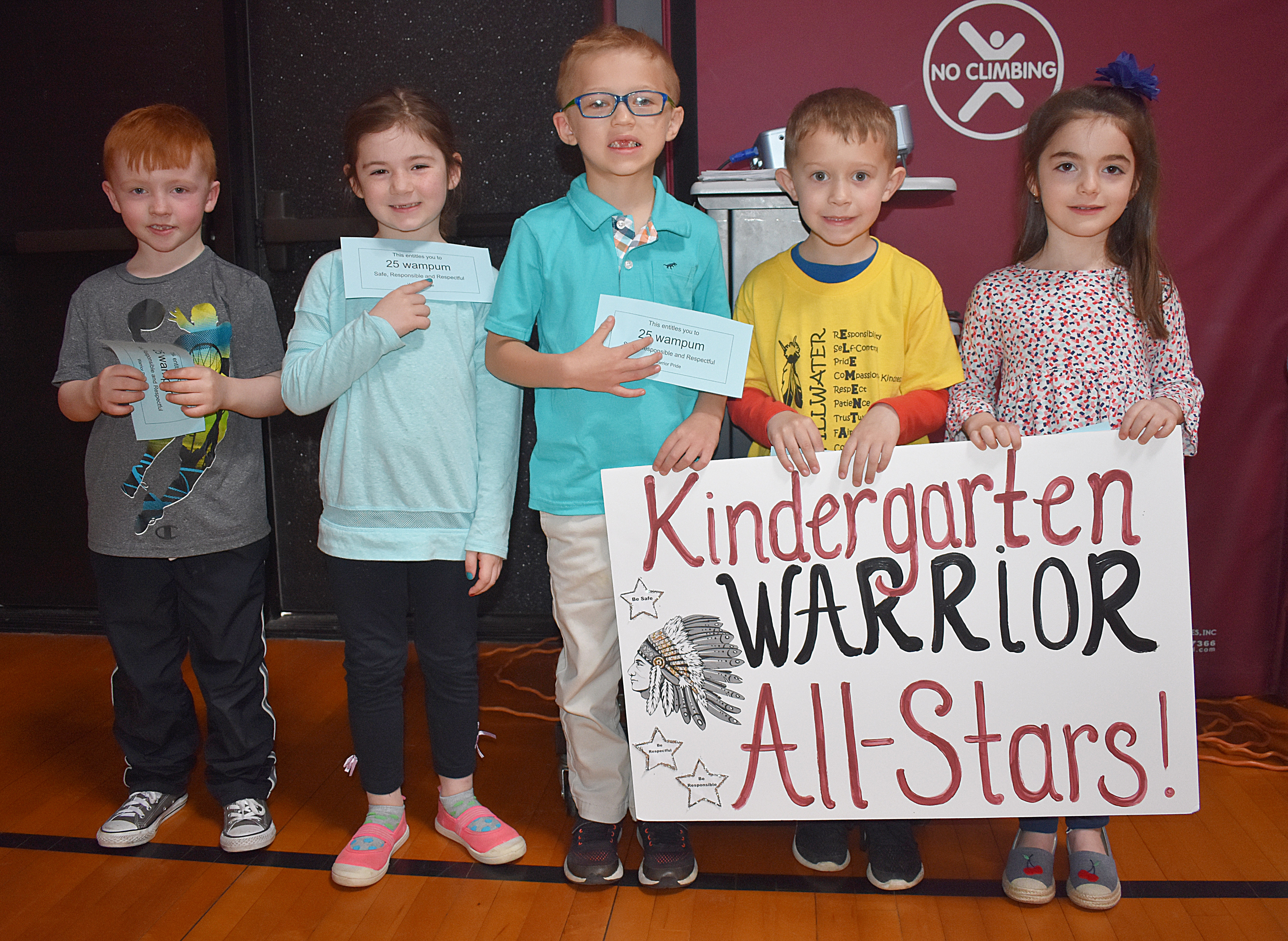 Kids standing with kindergarten sign