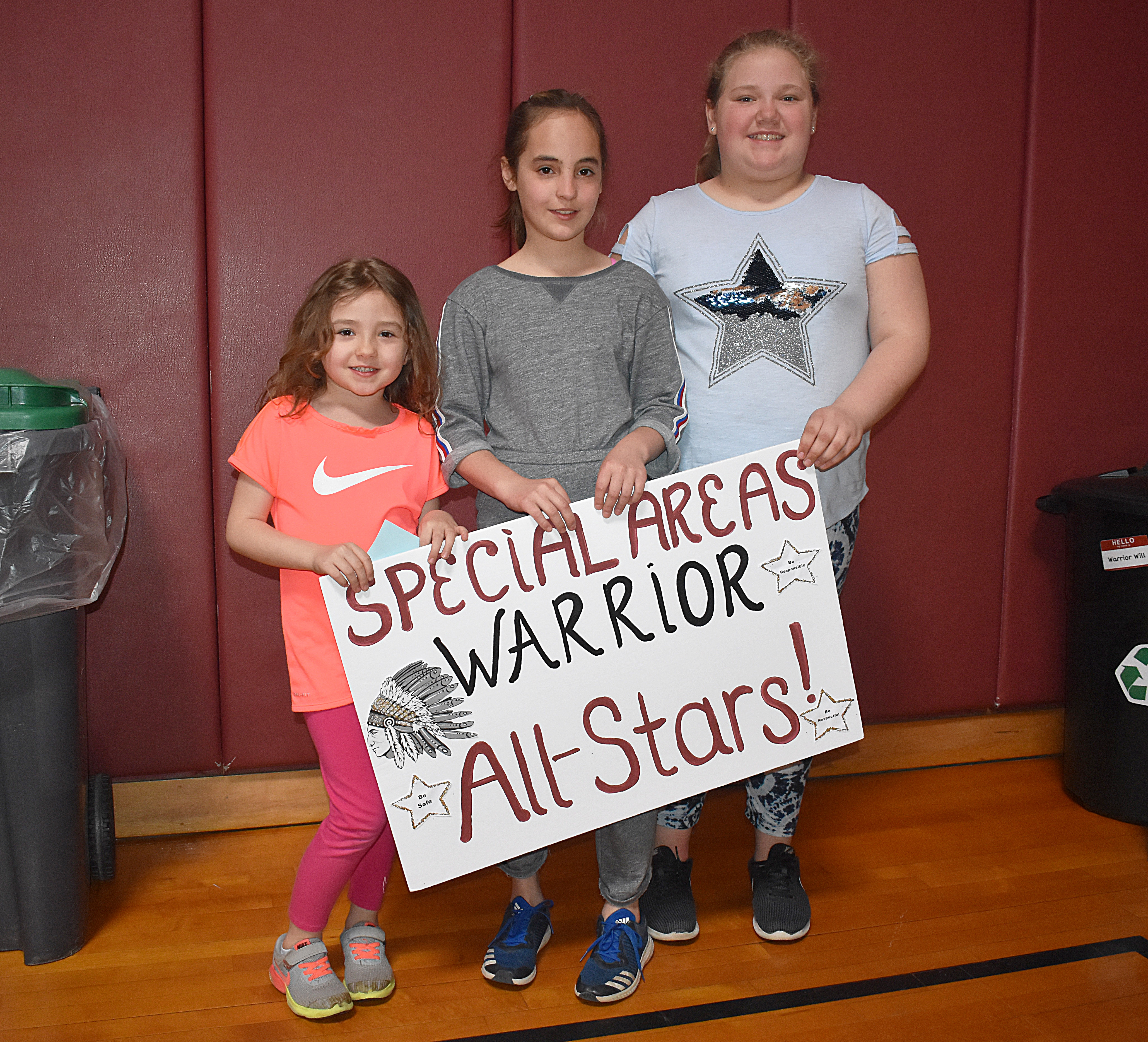 Students standing with the specials sign