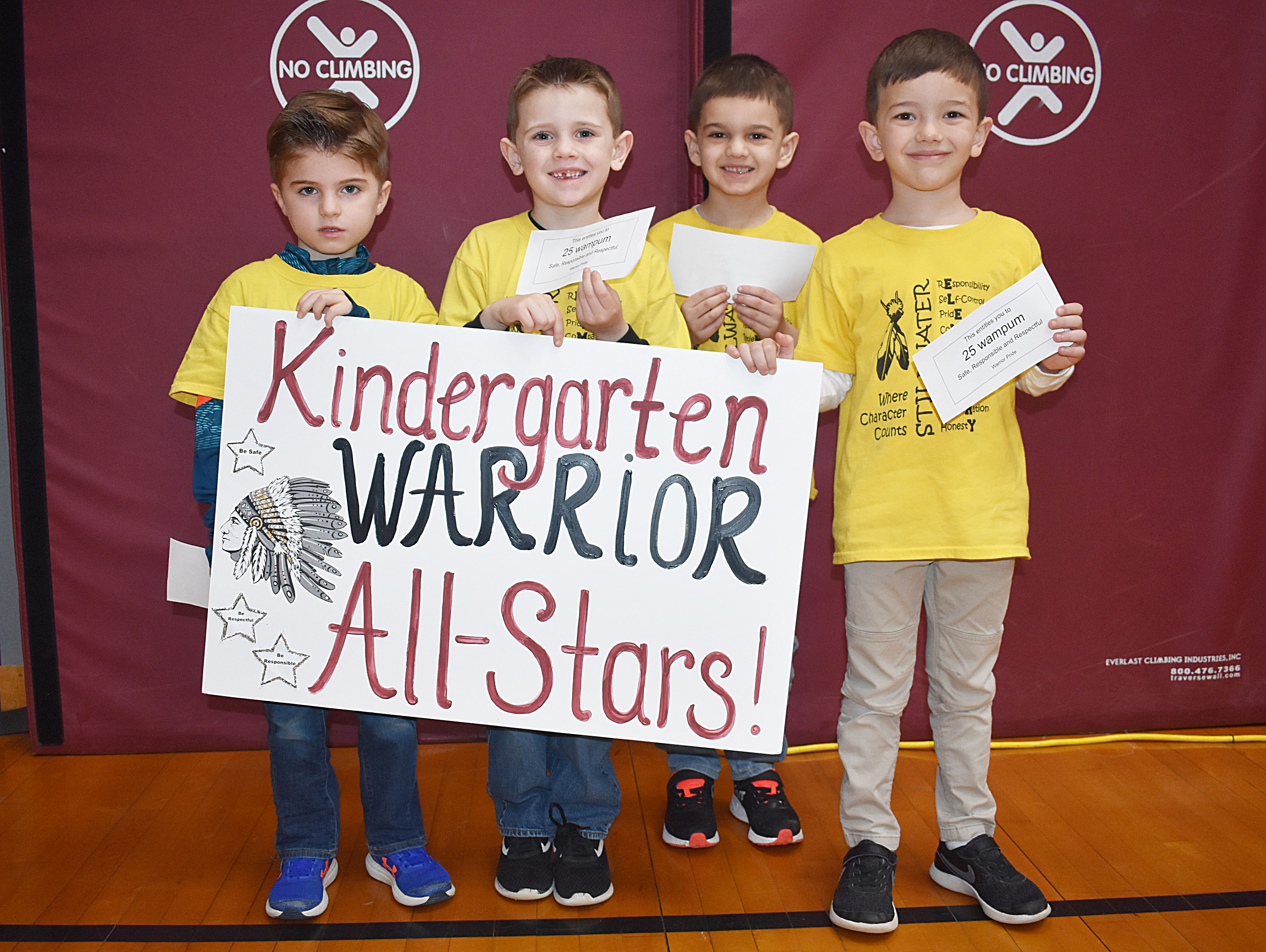 Grouo of kindergarten students gathered together for a picture with their all star sign