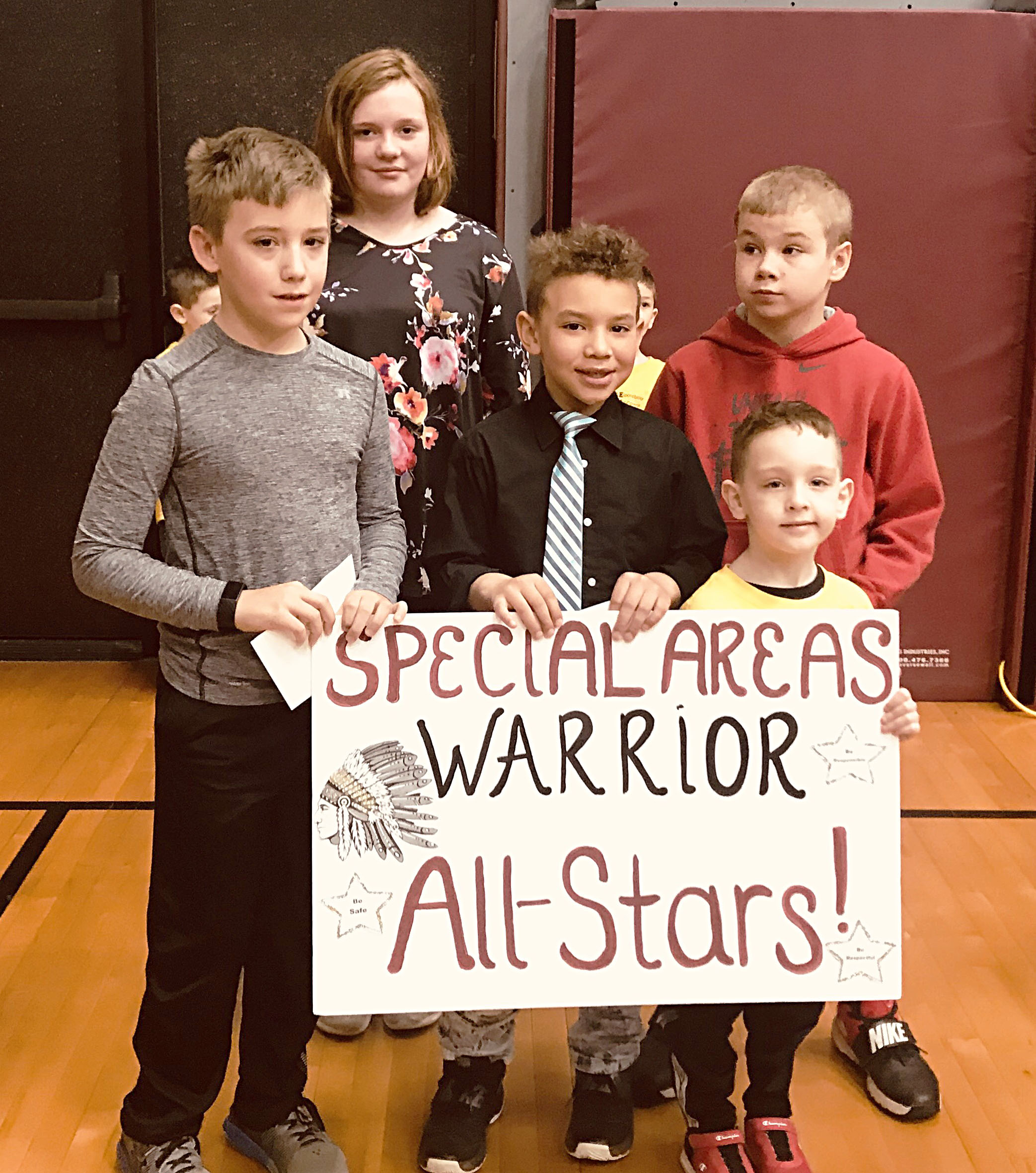 Students gathered together with specials sign