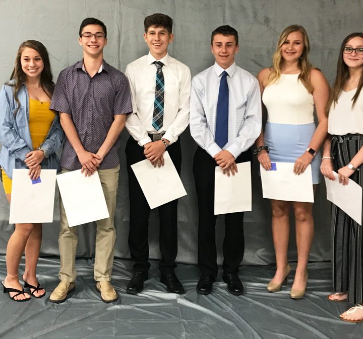 10th graders standing with their certificates