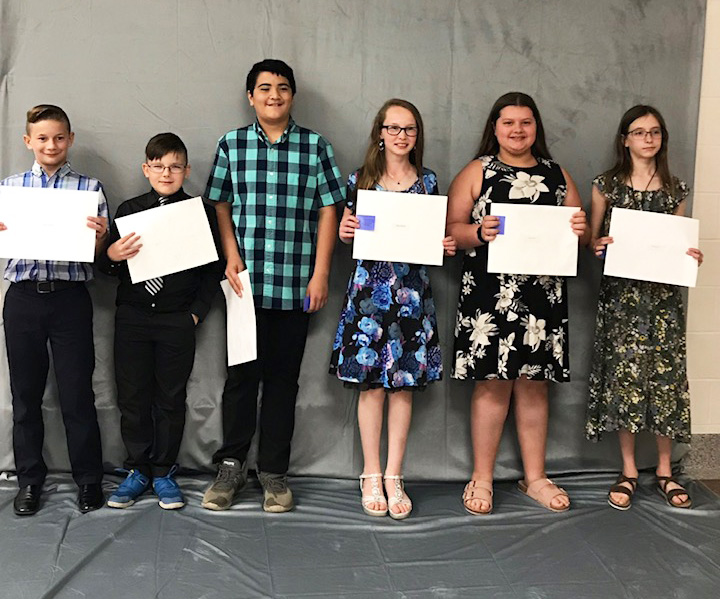 Students lined up with certificates