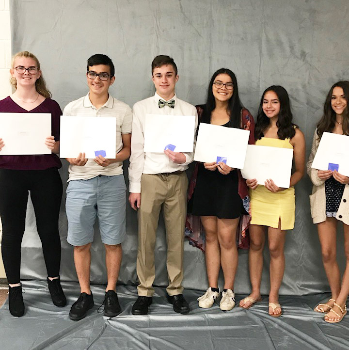 8th grade students lined up with their certificates