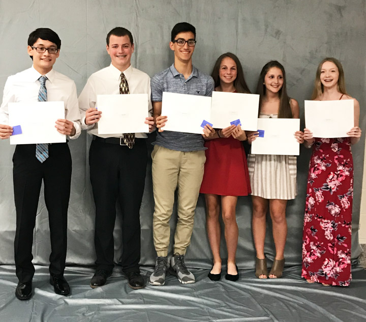 9th grade students standing with their certificates