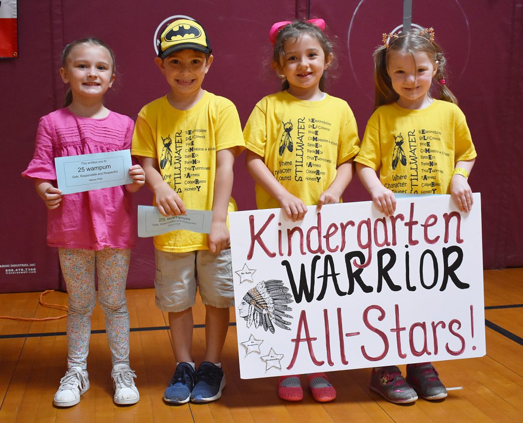 Kindergarten students with sign