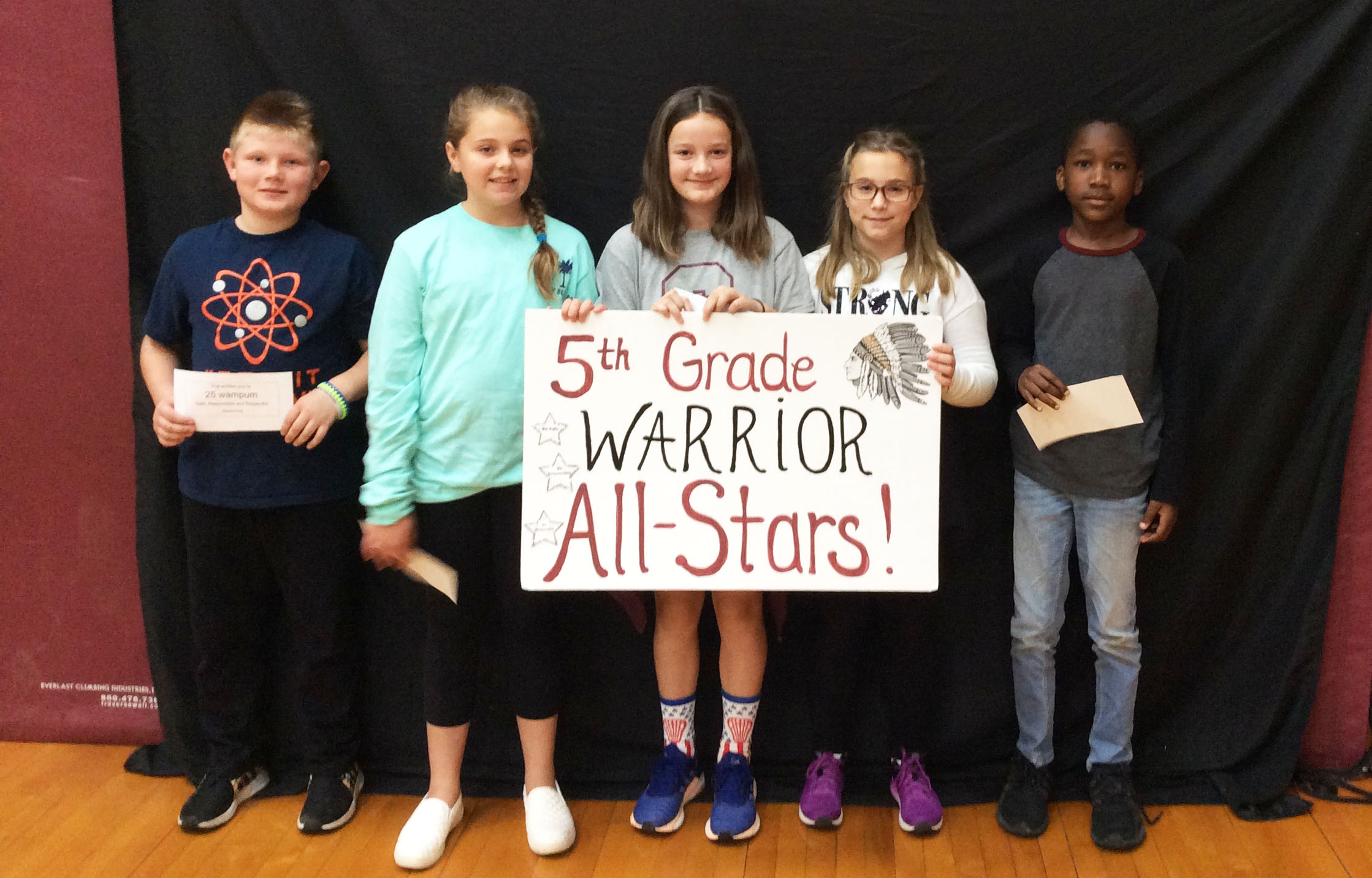 Students standing together with a sign in front of them