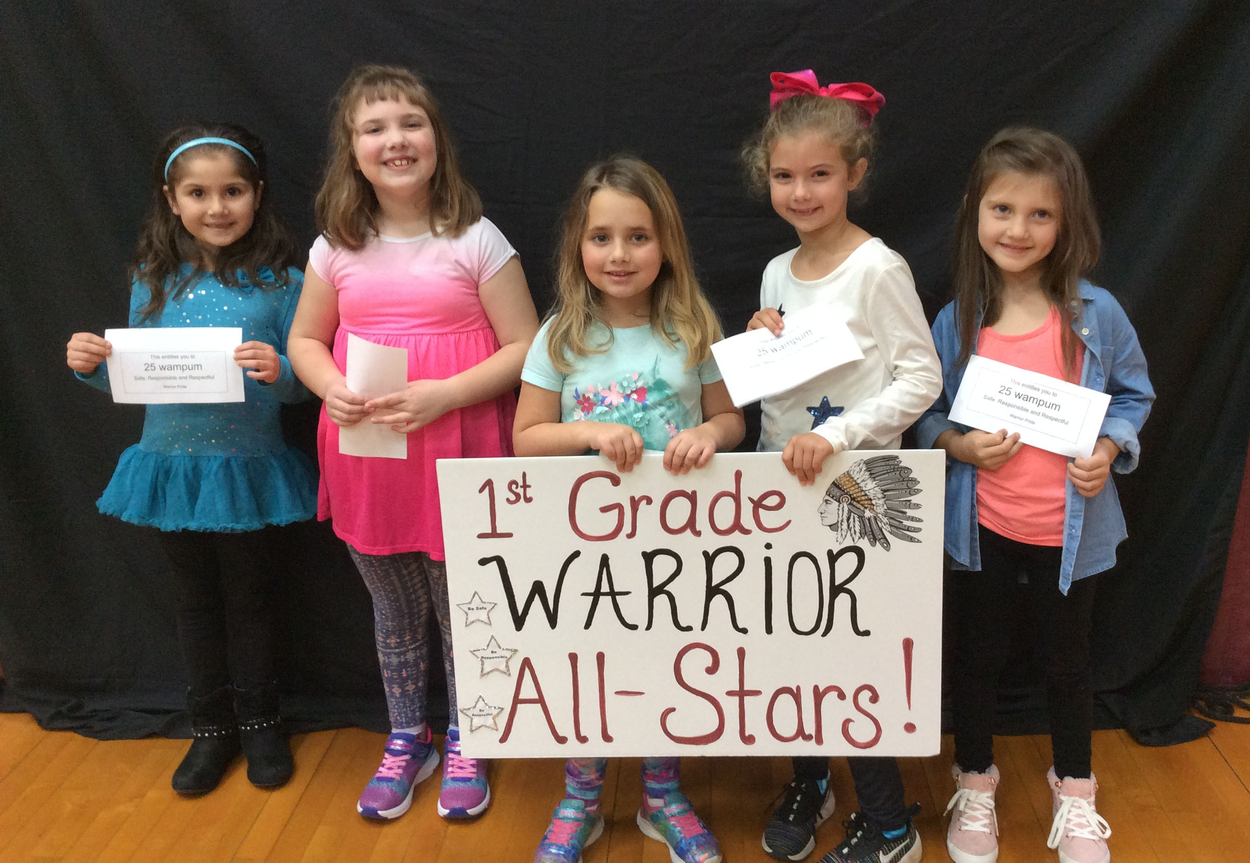 Students standing together with a sign in front of them