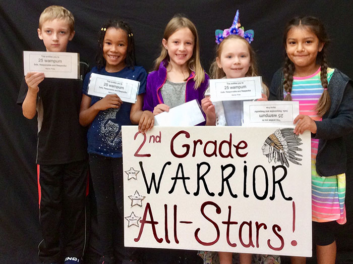 Second grade warrior all stars standing with sign