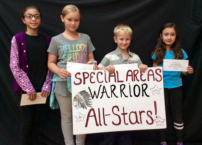 Four specials all stars students standing with specials sign