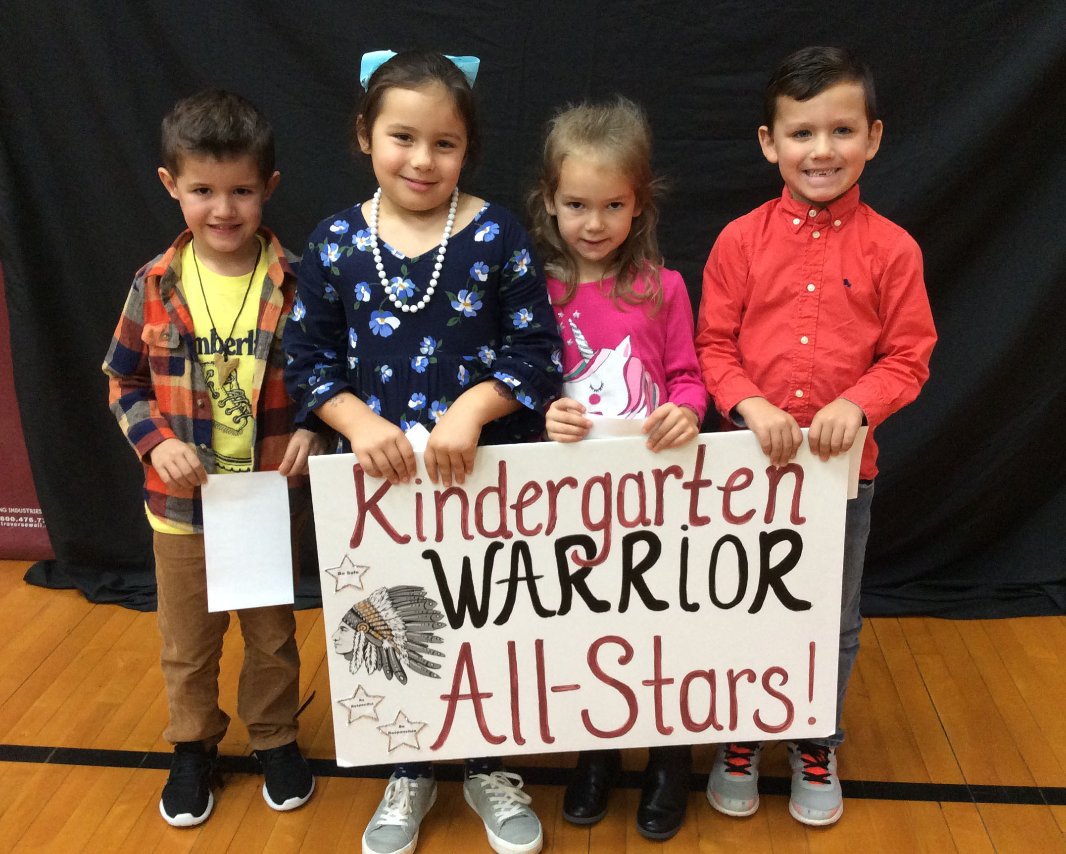 Students standing together with a sign