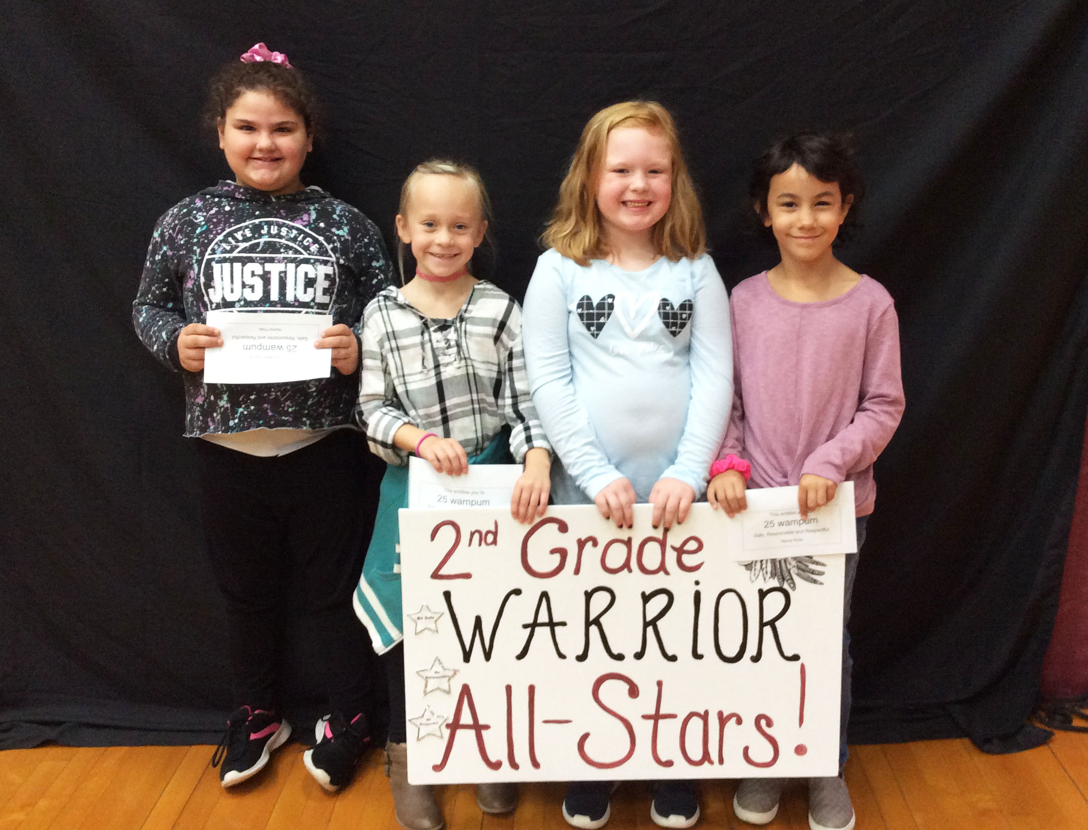 Students standing together with a sign in front of them