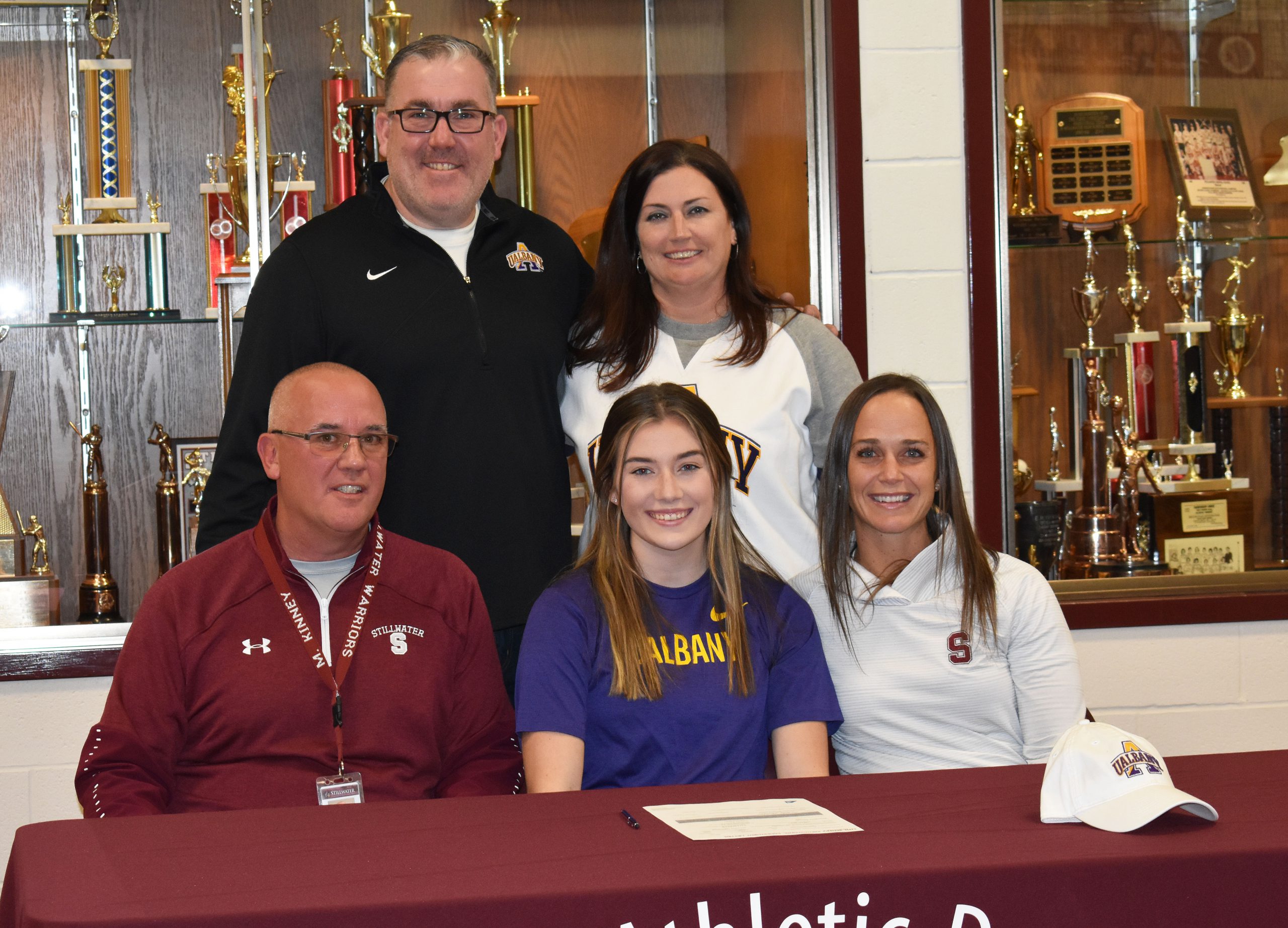 Brooke sitting at a table with parents, coach and athletic director