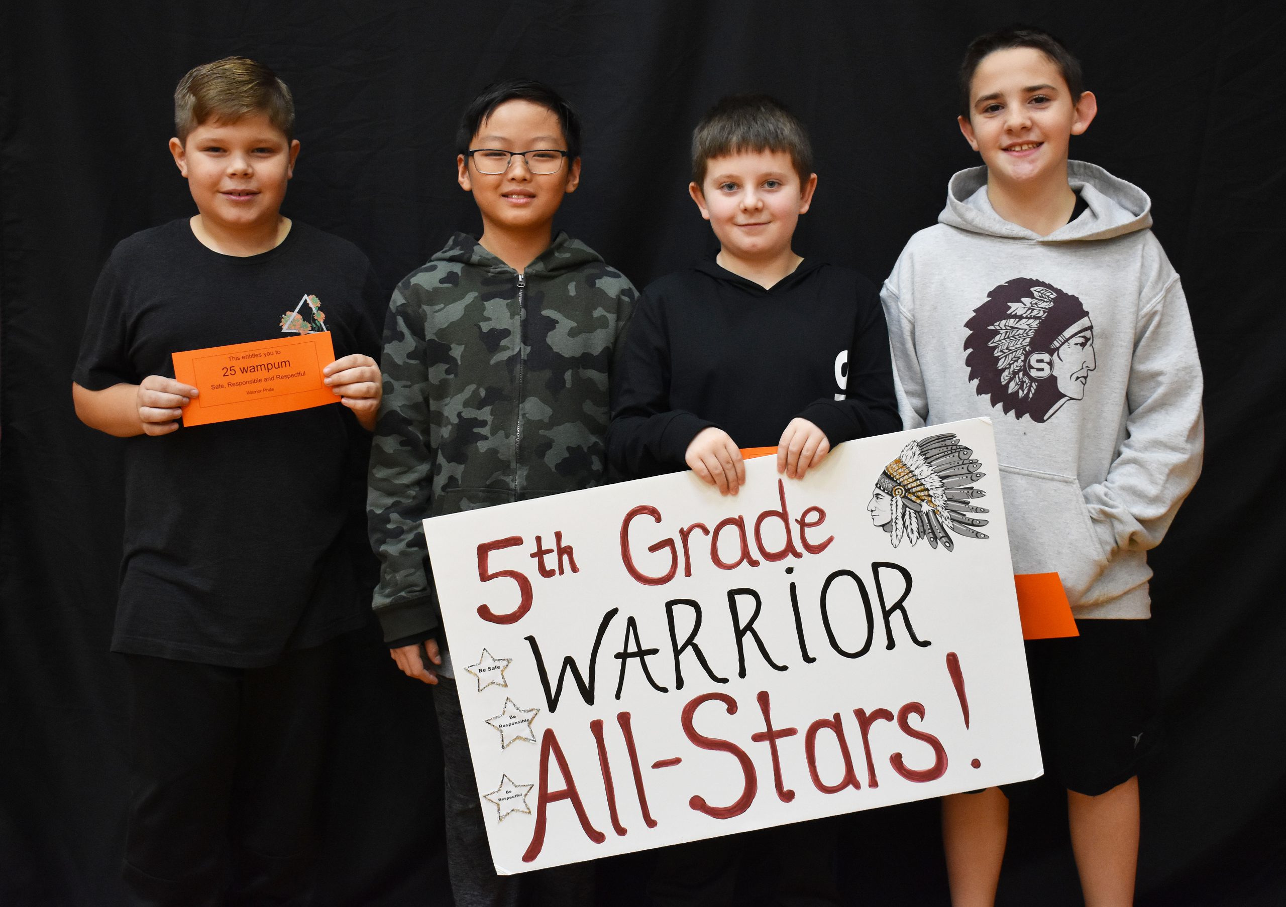 Students lined up with the fifth grade warrior sign