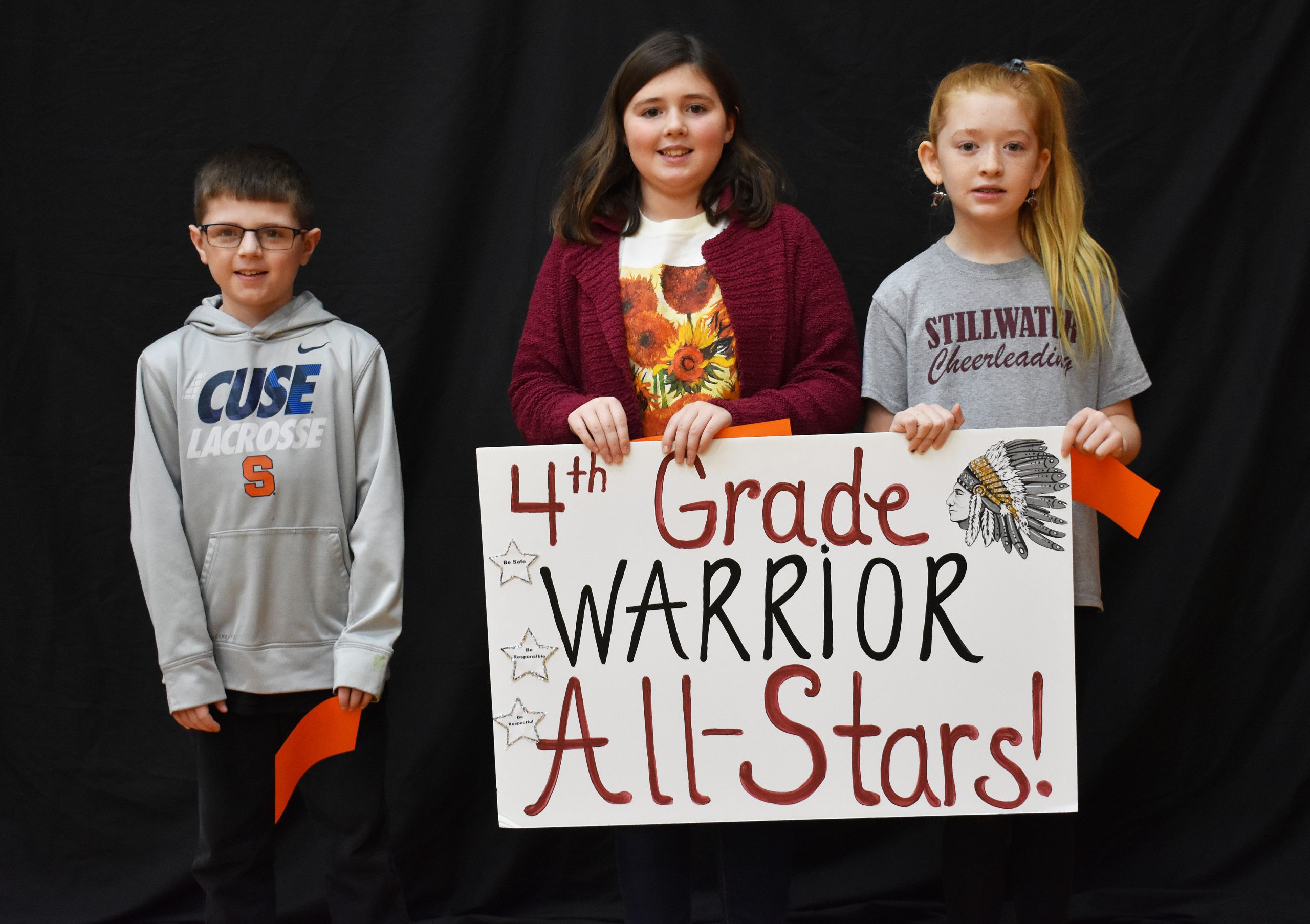 Students lined up with the fourth grade warrior sign