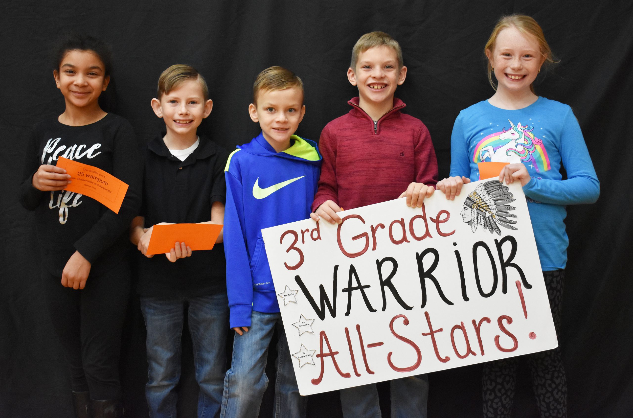 Students lined up with the third grade warrior sign