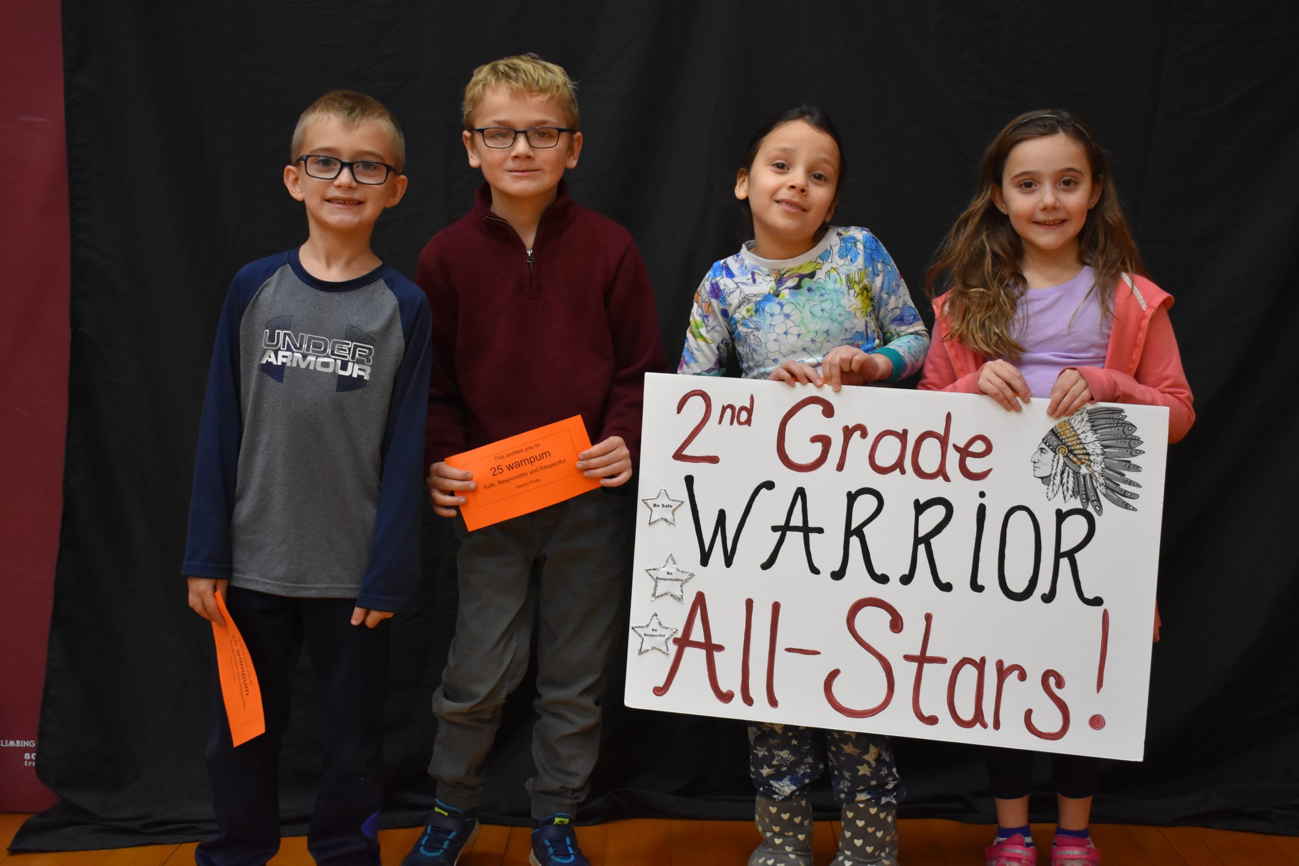 Students lined up with the second grade warrior sign