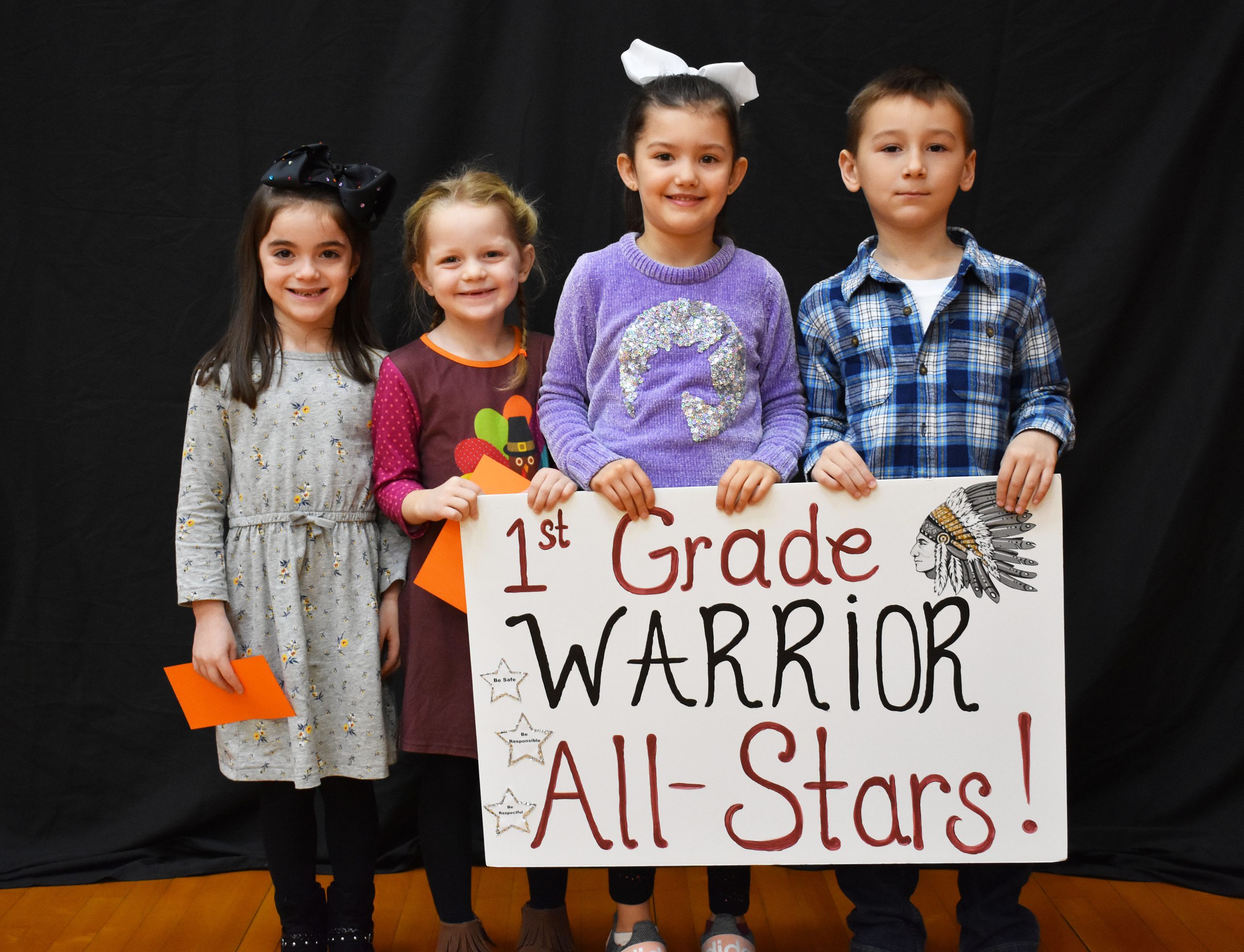 Students lined up with the first grade warrior sign