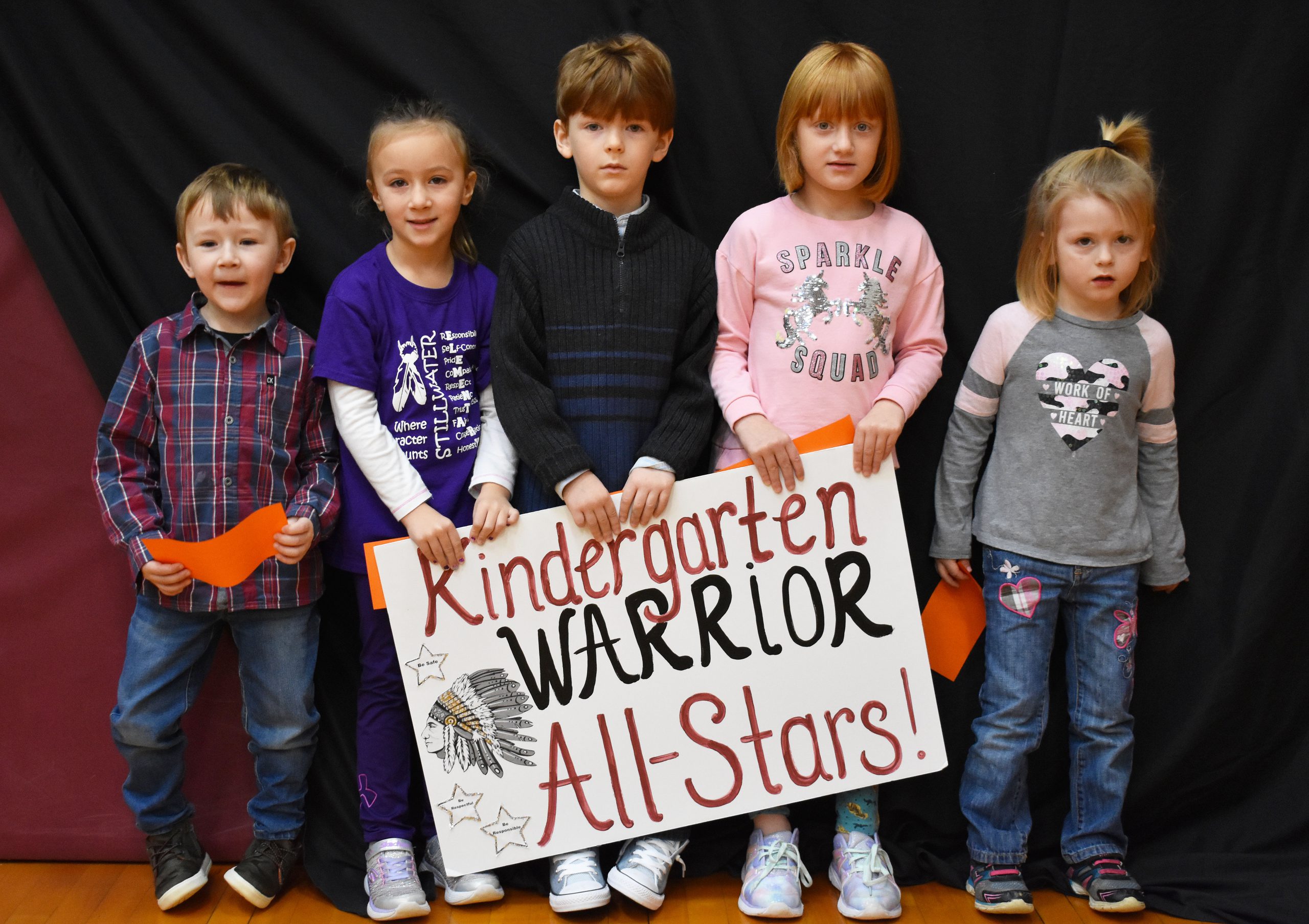 Students lined up with the kindergarten warrior sign
