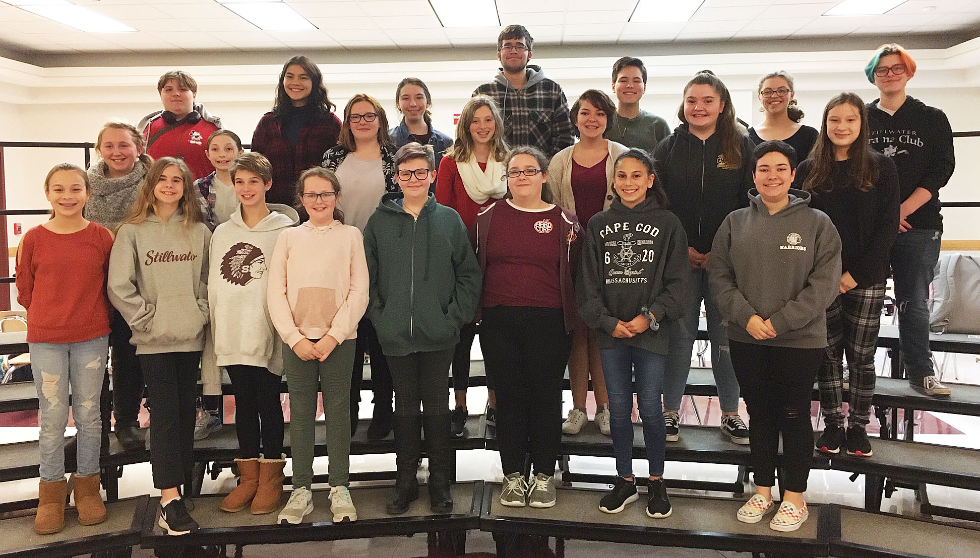 22 students standing on risers smiling