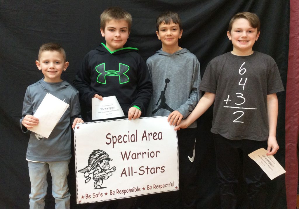 Four students standing with special area warrior all star sign