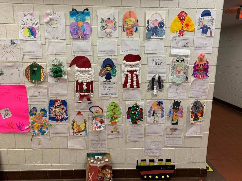 Photo of student artwork on the wall which are turkeys the students disguised as other things.