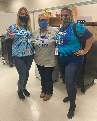 3 teachers standing together wearing Choose to Include shirts