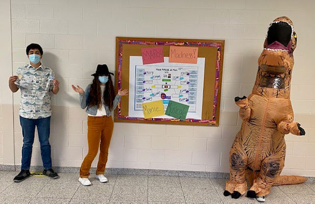 students in front of bulletin board showing music brackets
