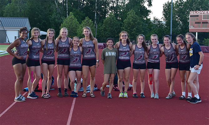 girls varsity track & field team pose as a group at sectionals