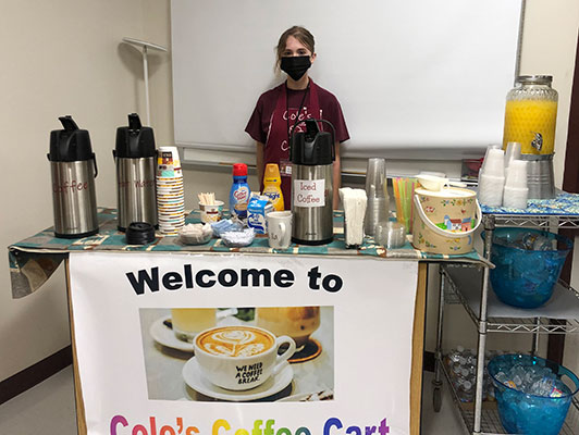 student standing at serving cart