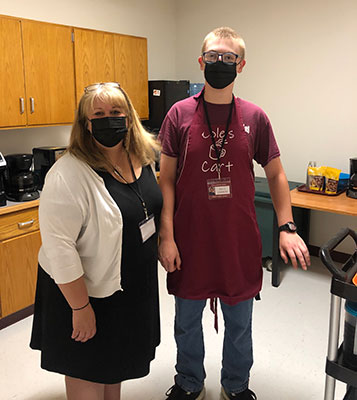 teacher and student standing together