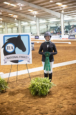 Jessica holding ribbon in arena