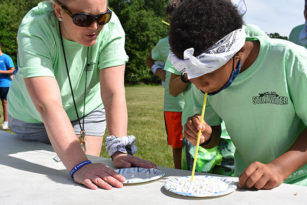 student playing move the mini-marshmallow