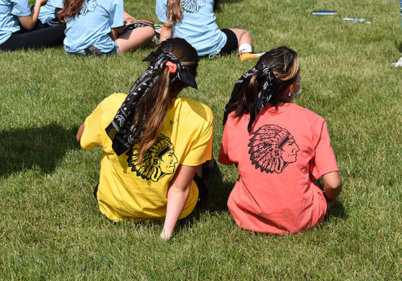 2 students wearing warrior tee shirts