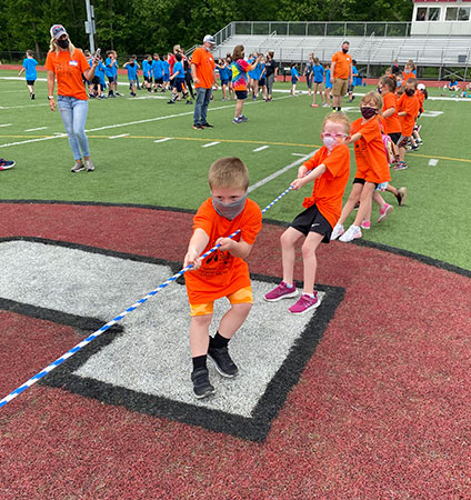 Students holding rope during tug of war 