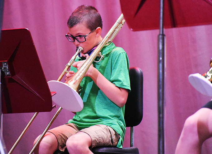 student playing trombone on stage