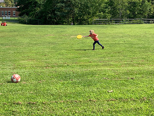 a student playing with a frisbee