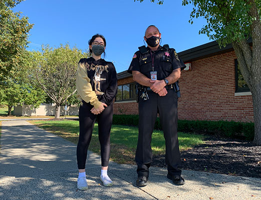 Shayla Colarusso and Deputy Sean Lyons standing outside school